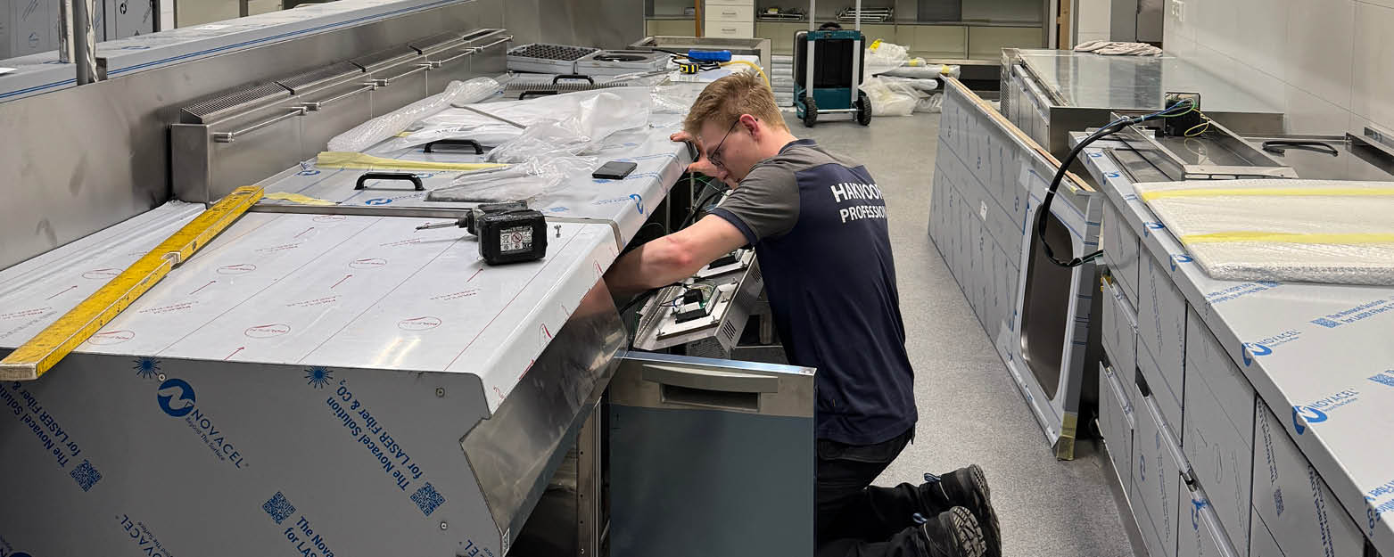 installatiemonteur van Hakvoort Professional die een grootkeuken aan het plaatsen is
